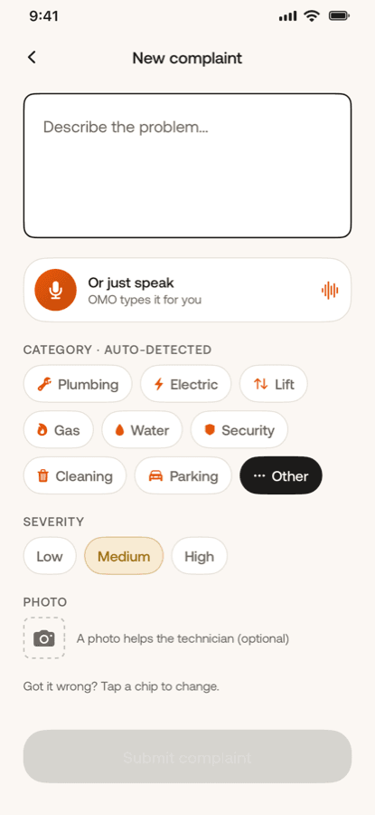 The new complaint screen: a voice button reading OMO types it for you, above a row of categories marked auto-detected